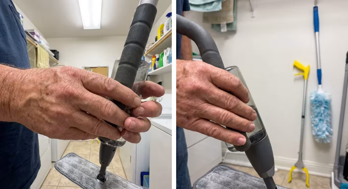 Close-up of a person's hands holding an ergonomic spray mop with a thick rubberized handle.